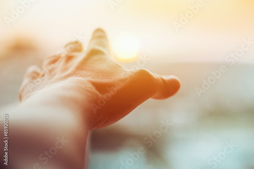 hand reaches for the sun