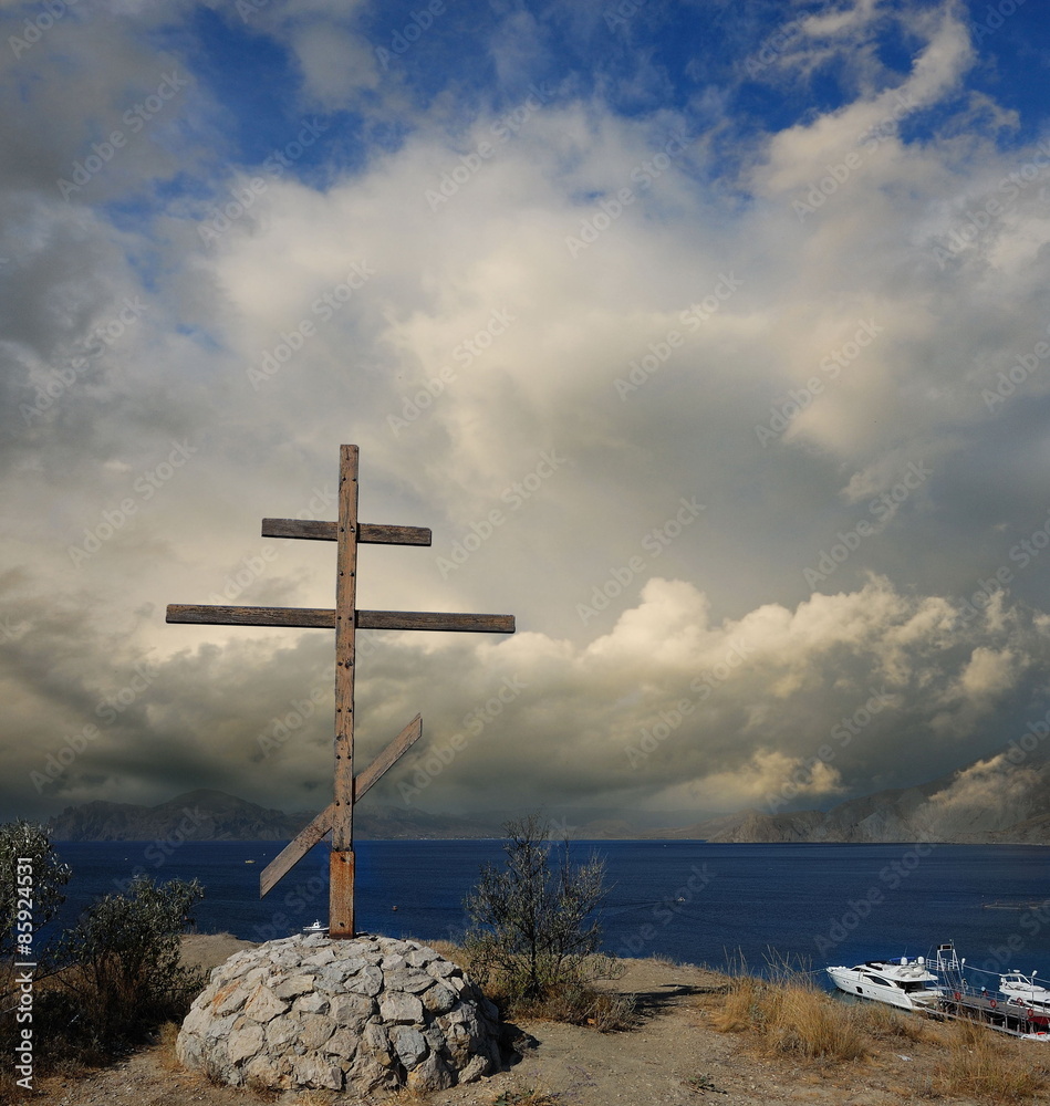 At the height of. Greece. Orthodox wooden cross. The monument on the hill near the shore 
