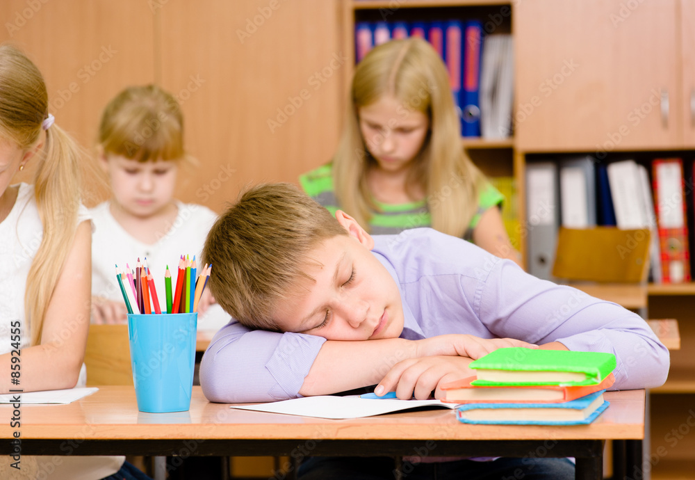 tired student boy sleeping in classroom tired student boy sleeping in classroom