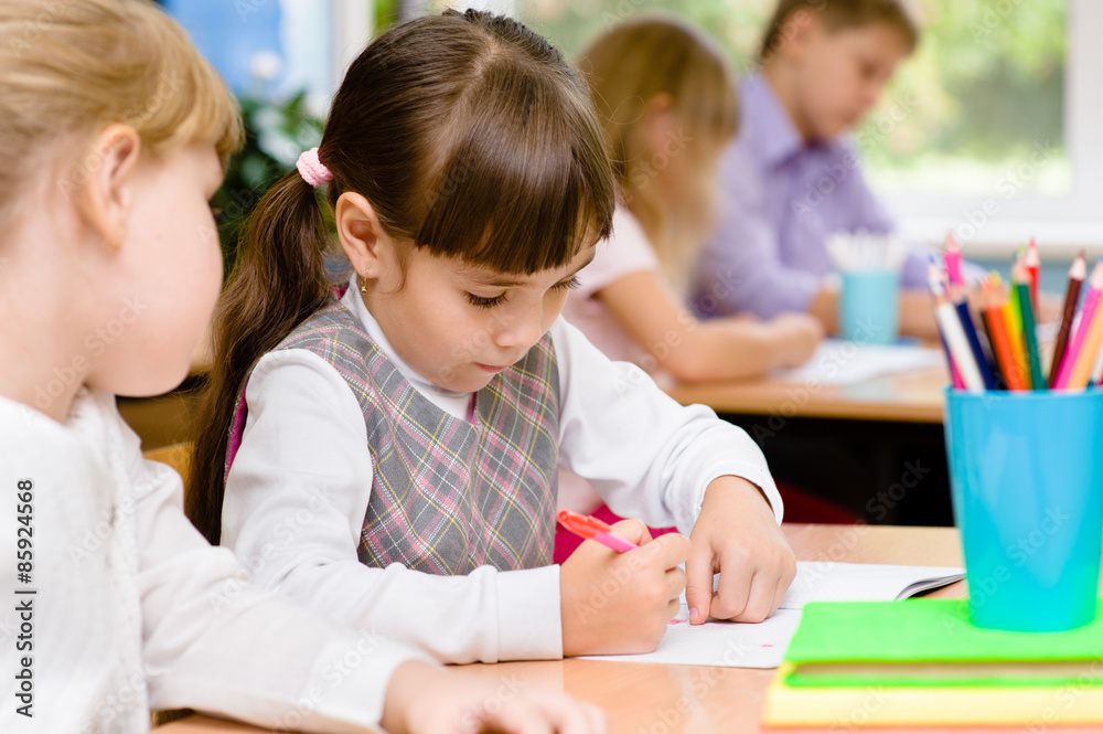 Primary school pupils write in their notebooks Primary school pupils write in their notebooks