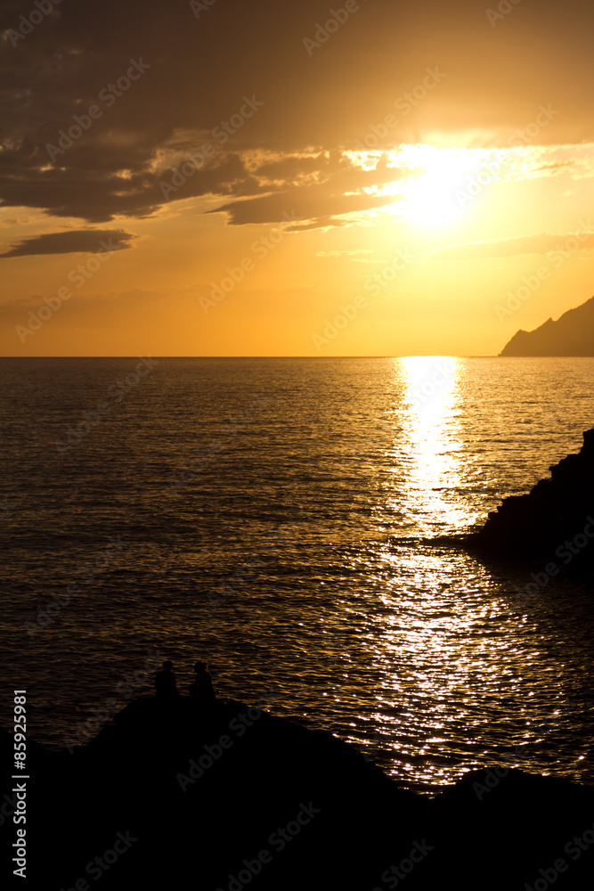 Couple enjoying the view of the sunset from Manarola, Cinque Ter