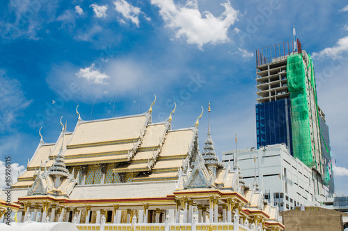 White stucco thai buddhist temple with cloud