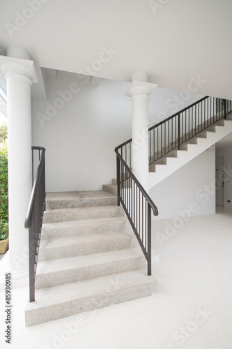 Stone staircase with black iron handrails