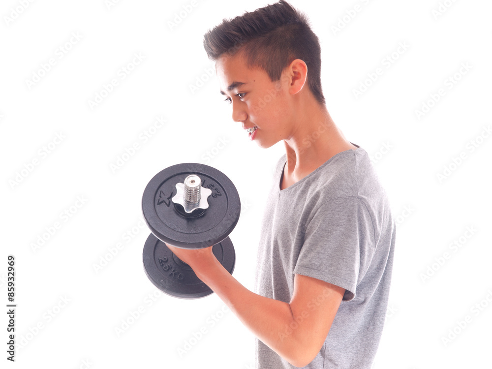 teenage boy exercising with a dumbbell teenage boy exercising with a dumbbell