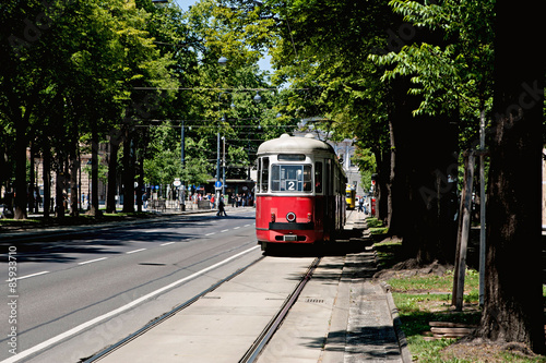 Tram car running along the line in city 