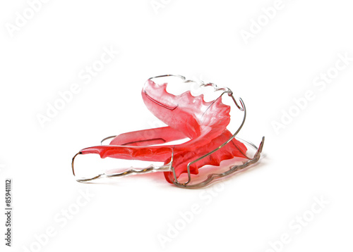 Fotografija Red dental retainer orthodontia, isolated on white background