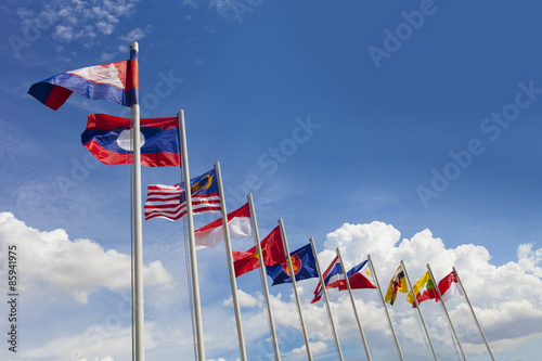 AEC flag, ASEAN flag, and the national flags of Southeast Asia countries on beautiful blue sky backgrond photo