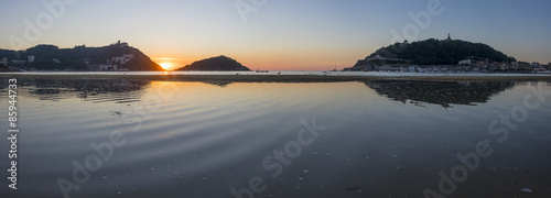 Summer sun sunset on the beach of La Concha in the city of Donostia