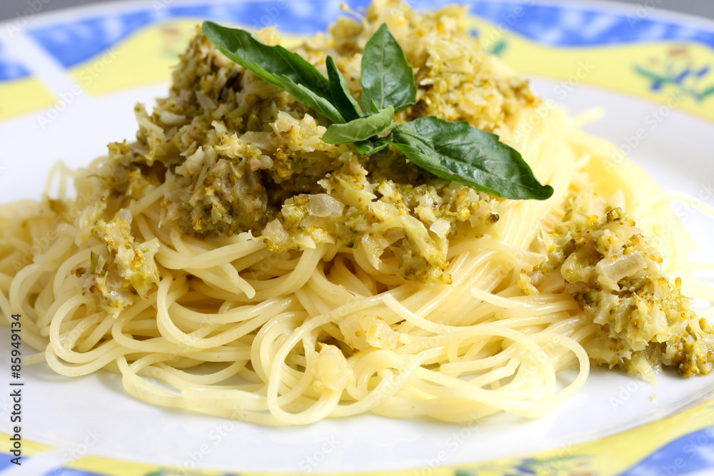 served pasta, spaghetti with cream sauce and zucchini on the plate
