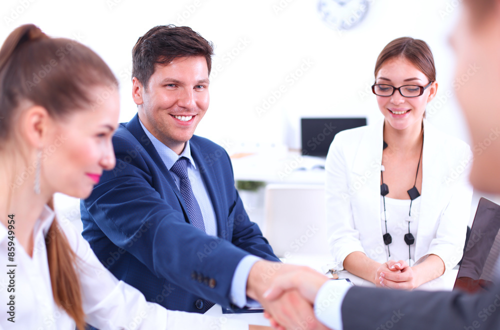 Business people shaking hands, finishing up a meeting, in office Business people shaking hands, finishing up a meeting, in office