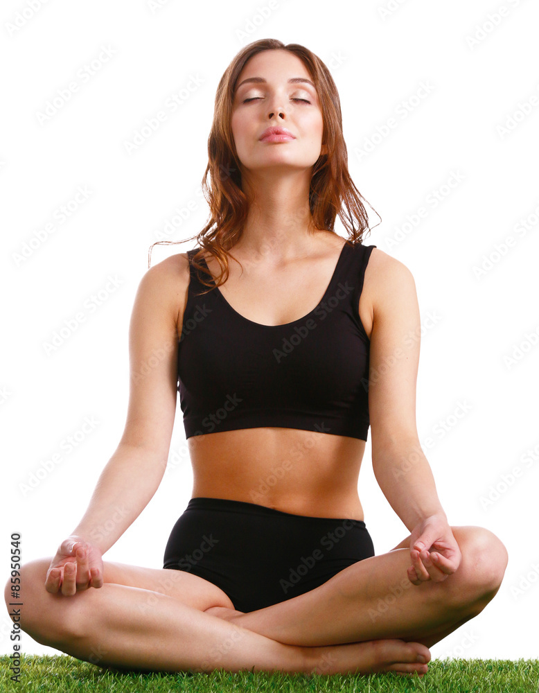 Young woman practicing yoga in the lotus position Young woman practicing yoga in the lotus position