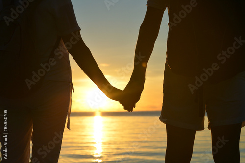 Senior couple at sea at sunset