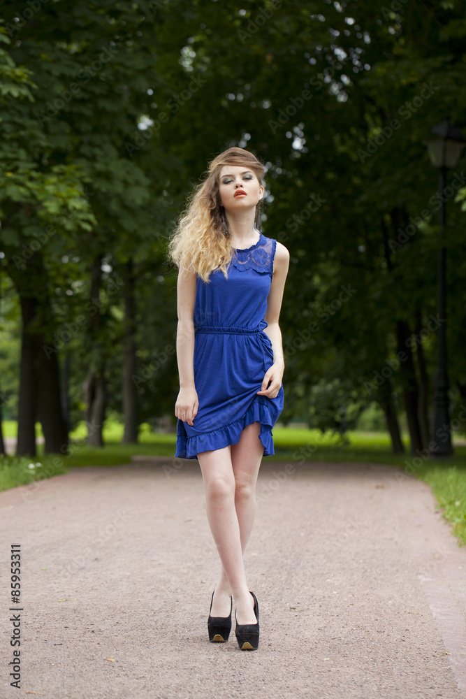 Beautiful young blonde woman in blue dress Beautiful young blonde woman in blue dress