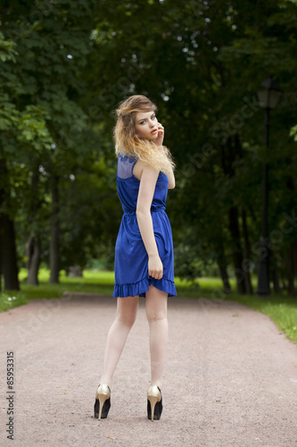 Beautiful young blonde woman in blue dress