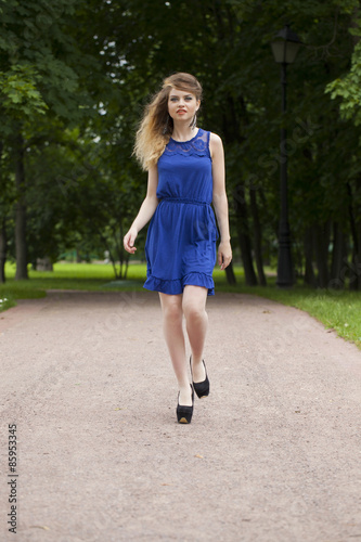 Beautiful young blonde woman in blue dress