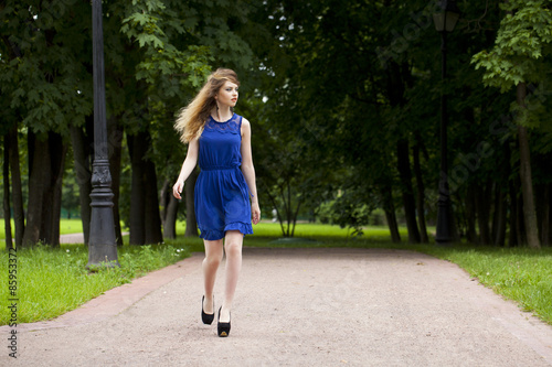 Beautiful young blonde woman in blue dress © Andrey_Arkusha