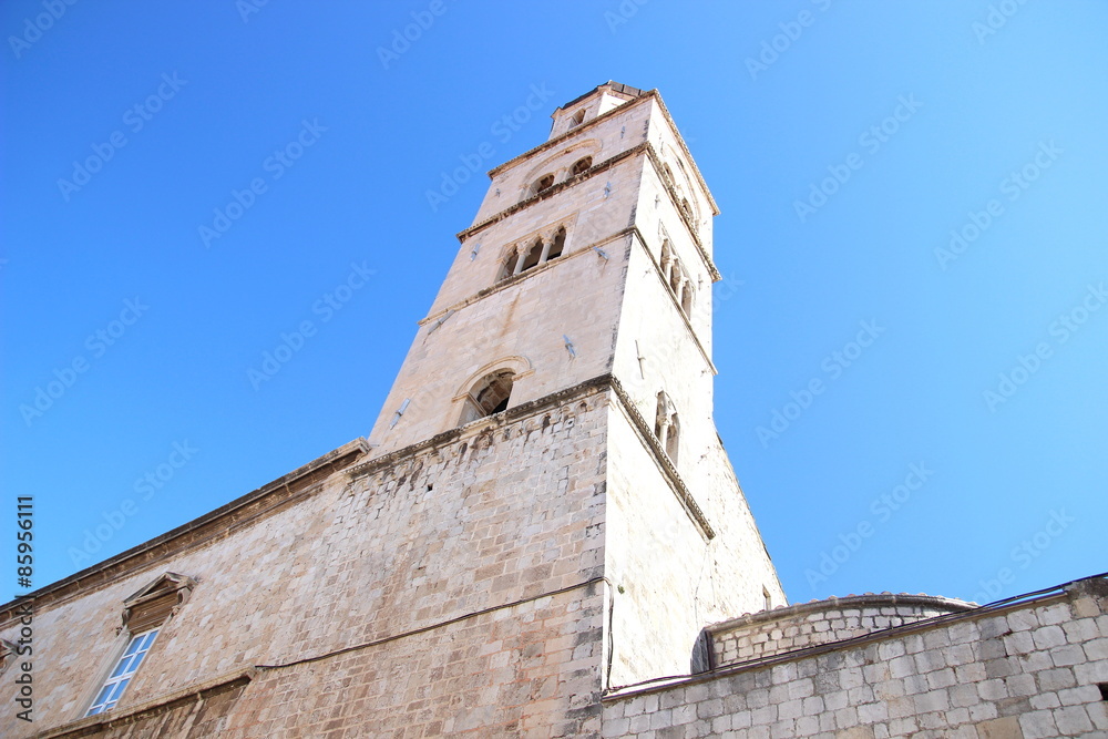 Church belfry in Dubrovnik town in Croatia and blue sky
