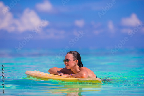 Beautiful fitness surfer woman surfing during summer vacation © travnikovstudio