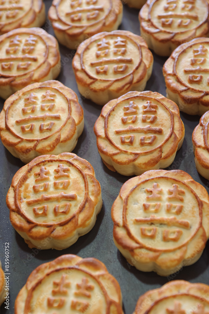 fresh mooncakes on a baking pan fresh mooncakes on a baking pan