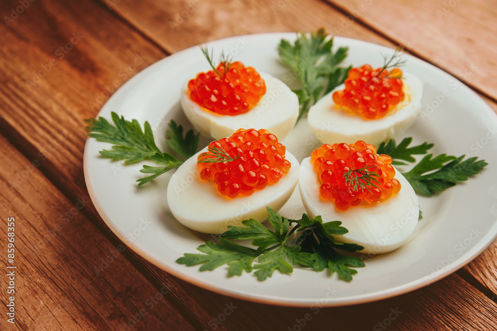 Boiled eggs with red salmon caviar Boiled eggs with red salmon caviar