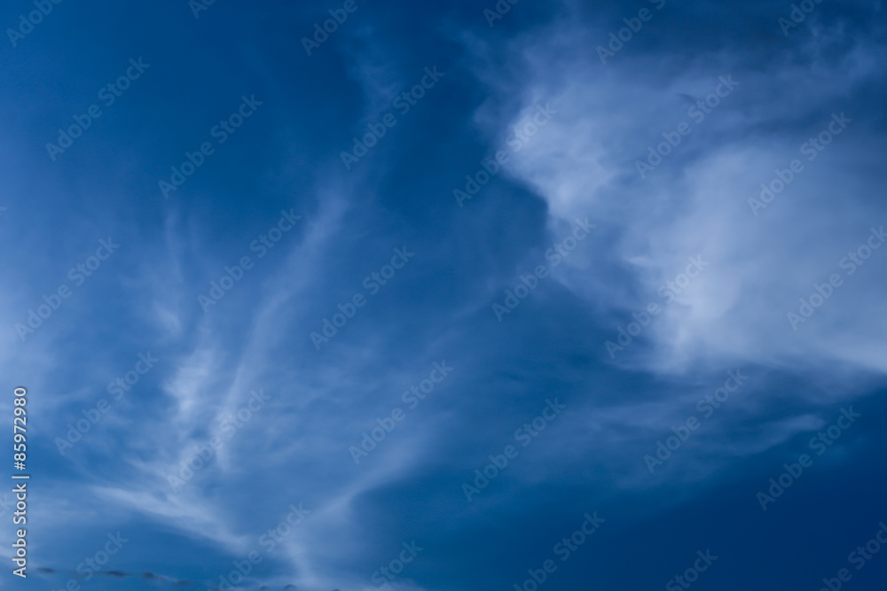 Sligtly clouds floating on the clear blue sky