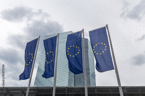 new european central bank in frankfurt germany with europe flags photo