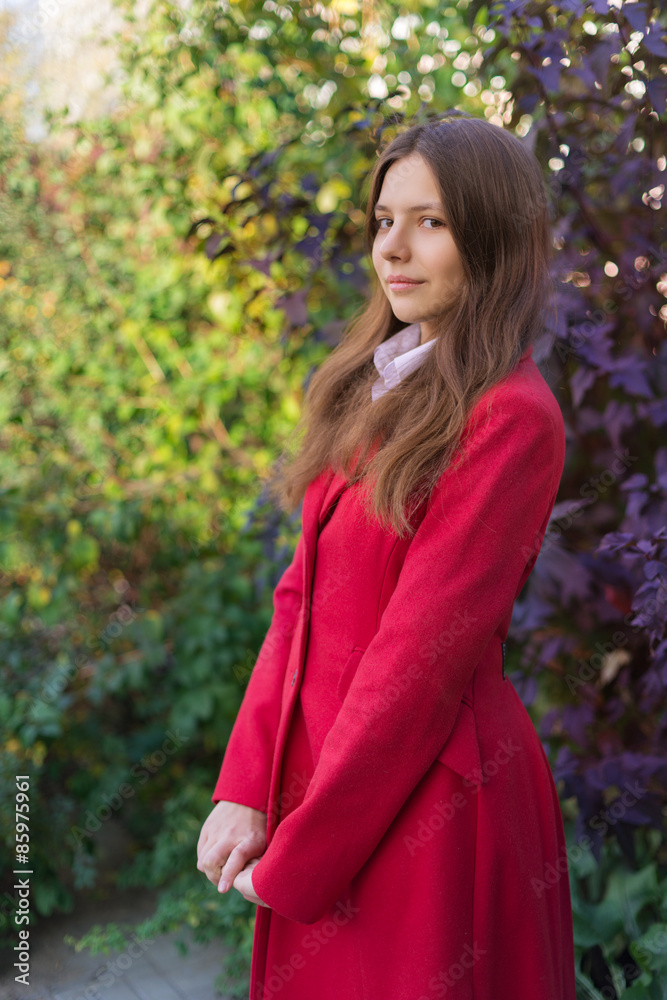 Young pretty woman standing in the autumn park Young pretty woman standing in the autumn park