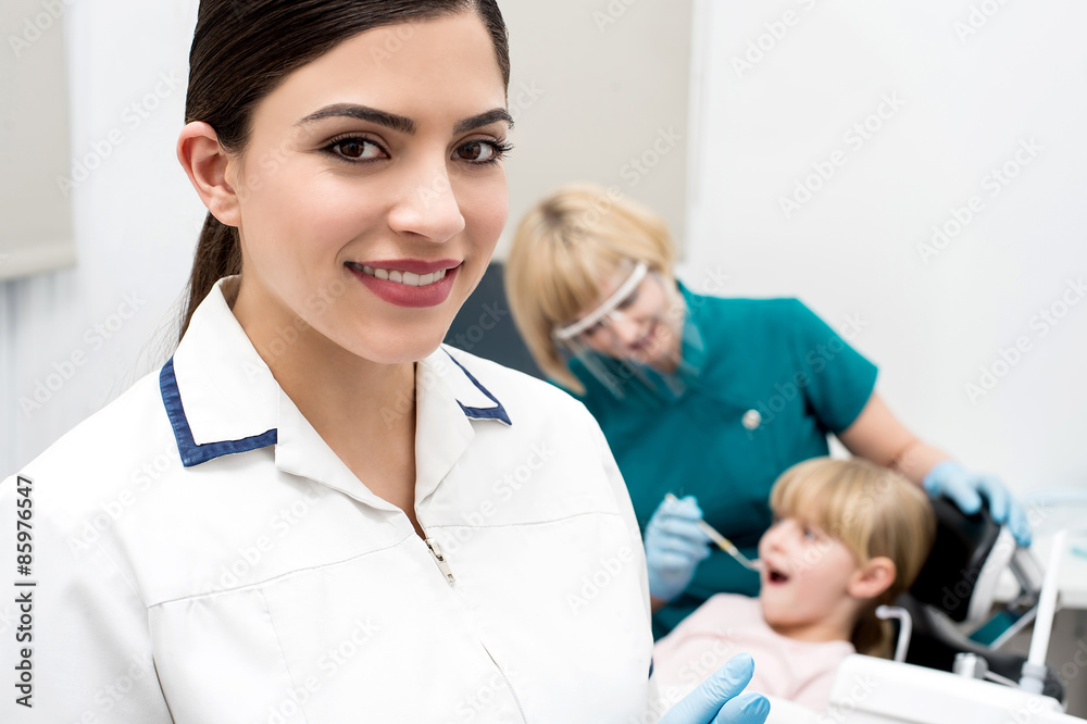Fototapeta premium Little girl treated at dental clinic