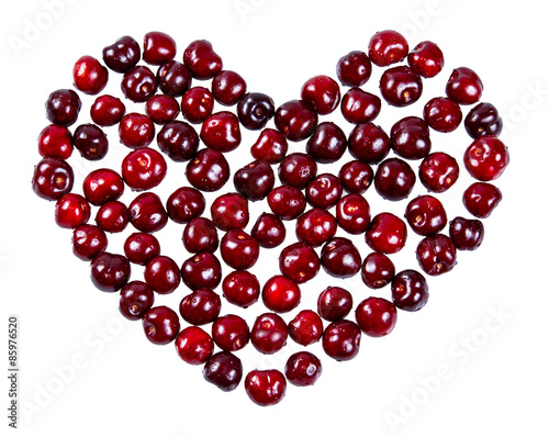 Heart made of cherries isolated on white background