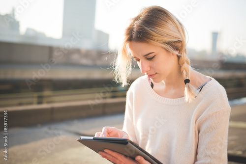 Free Download young beautiful blonde woman outdoor using tablet - GFXLoad