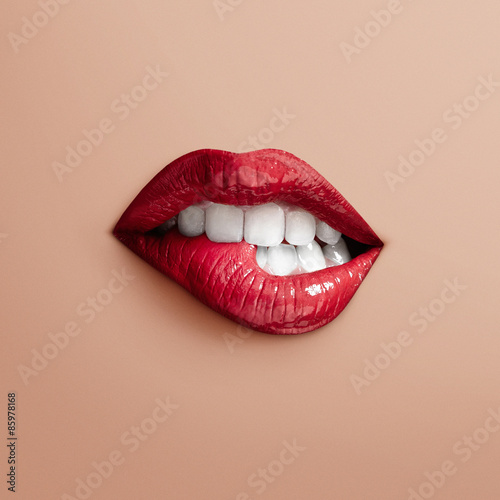 Photo bites separate lips on a beige background