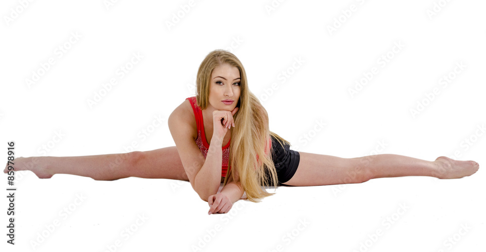 Beautiful long-haired cheerful girl is engaged in gymnastic exercises on the floor Beautiful long-haired cheerful girl is engaged in gymnastic exercises on the floor