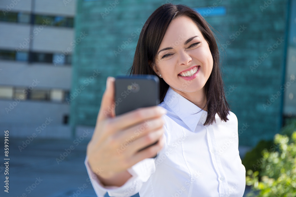 funny business woman making selfie photo on smartphone funny business woman making selfie photo on smartphone