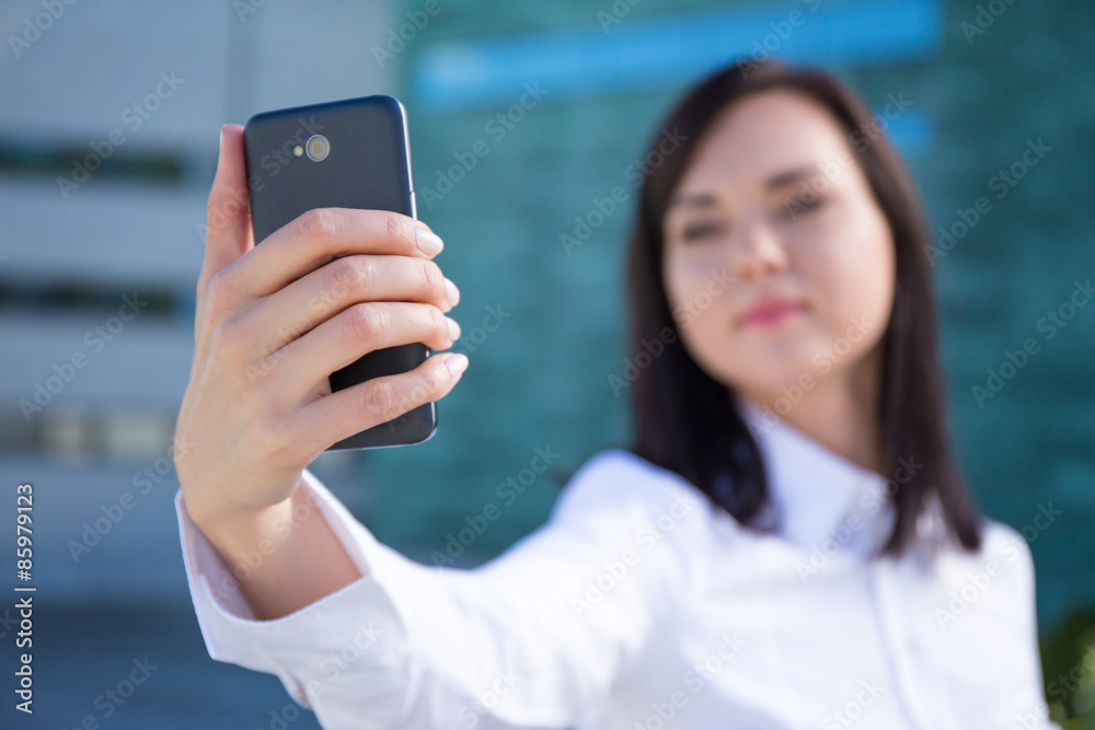 smartphone in beautiful business woman's hand