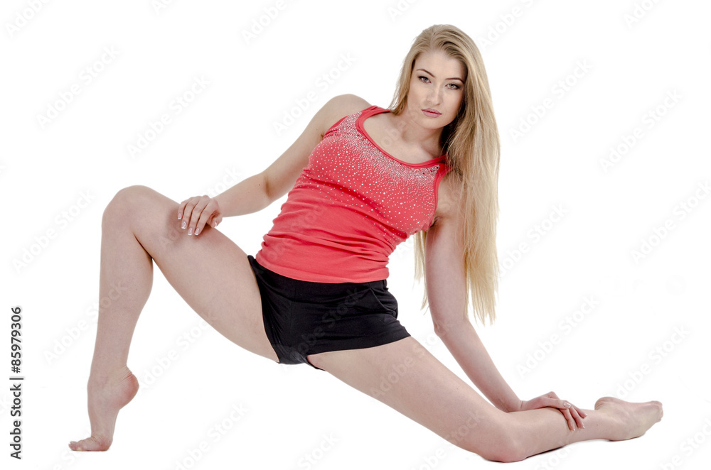 Beautiful long-haired cheerful girl is engaged in gymnastic exercises on the floor Beautiful long-haired cheerful girl is engaged in gymnastic exercises on the floor