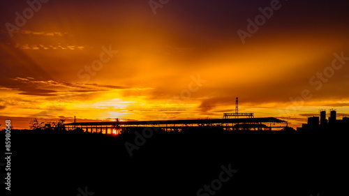 silhouette, sunrise over factory