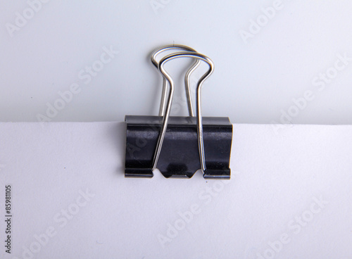 Black paper clip on paper