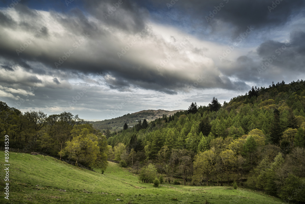 Lake District landscape with stormy sky over countryside anf fie