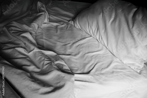 Messy white bed and pillow, in the morning