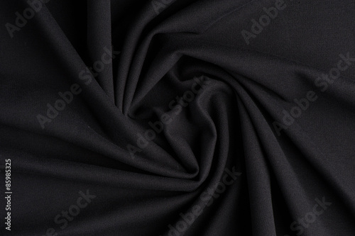 Spiral folds on black cloth
