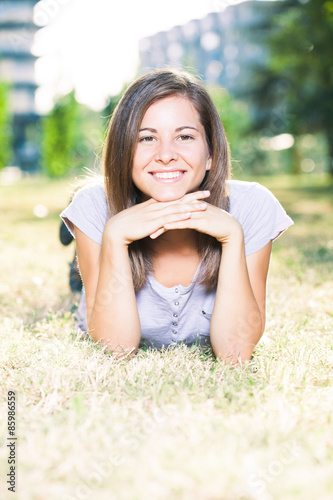 Young happy woman smiling on a summer day in park © djoronimo