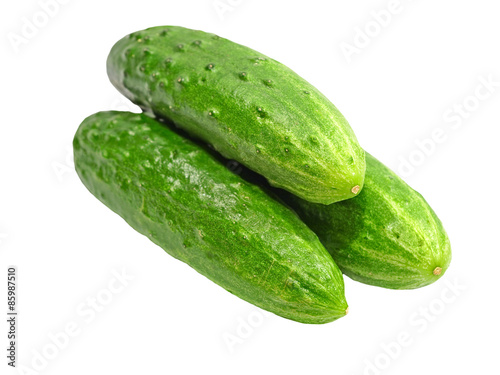 Three green cucumbers taken closeup.Isolated.