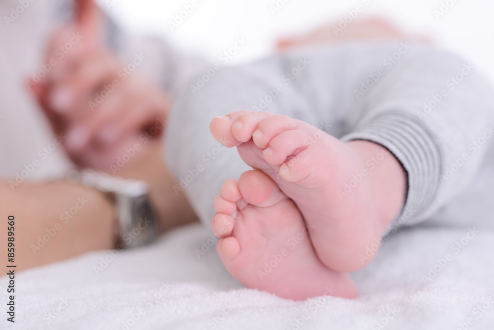 closeup shot of baby foot laying down on a white blanket closeup shot of baby foot laying down on a white blanket