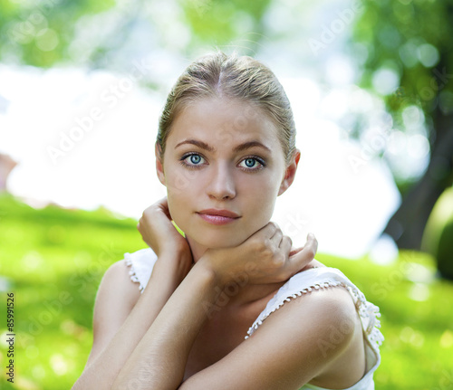 Portrait close up of young beautiful blonde woman  on background