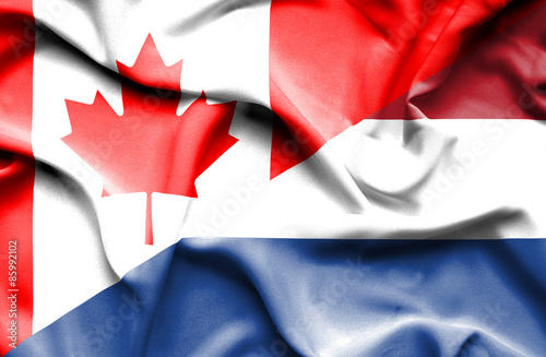 Waving flag of Netherlands and Canada