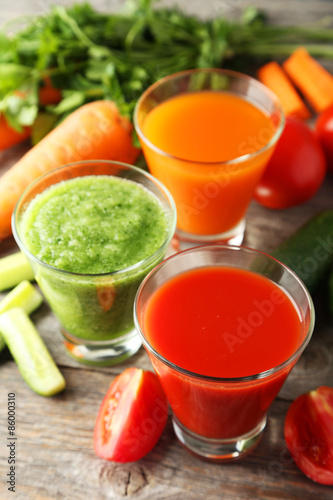 Fresh tomato, carrot and cucumber juice on grey wooden background © 5second