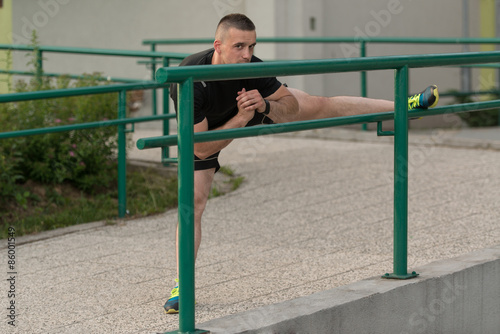 Young Man Is Streching Outdoors
