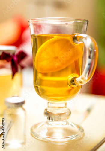 Closeup photo of hot tea with lemon in transparent glass
