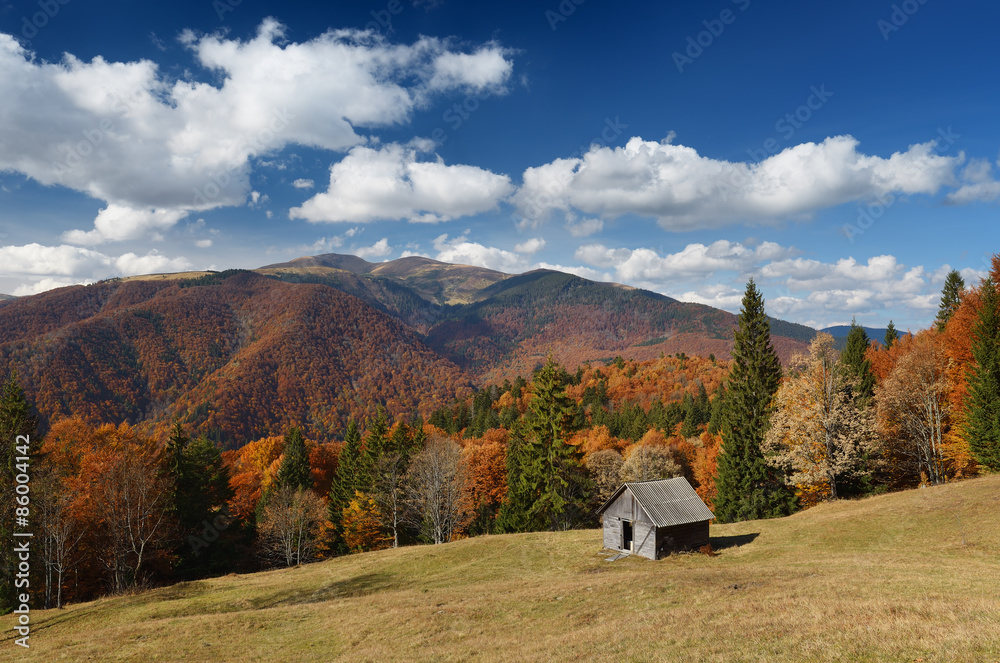 Autumn Landscape with a wooden house in the mountains
