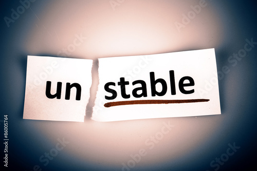 The word unstable changed to stable on torn paper photo